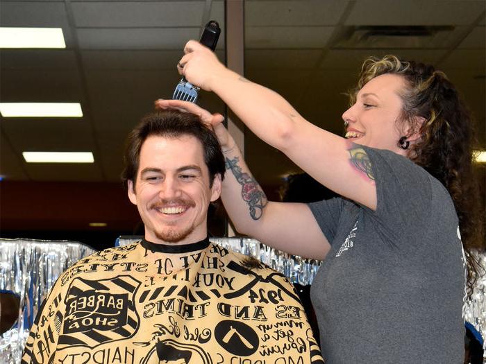 Student Jeff Romano smiles after achieving his donation goal and prepares for his haircut to begin during the 2025 THON hair auction at Penn State DuBois.