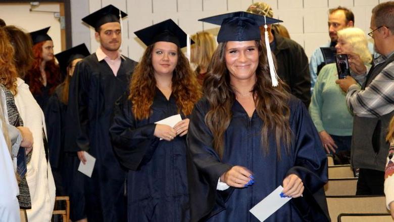 Graduates enter Hiller Auditorium during the processional at the beginning of the commencement celebration at Penn State DuBois.