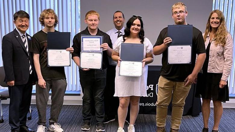 Students and staff members gather for a group photo during the graduation ceremony for the post high school CNC program at Penn State DuBois. From left to right, Pam Streich, executive director of  Workforce Solutions of North Central Pennsylvania, Luke Eckert, Skylar Bowers, John Brennan, director of continuing and community education at Penn State DuBois, Tyler Baughman, Hunter Tharp, Jungwoo Ryoo, chancellor and chief academic officer at Penn State DuBois.